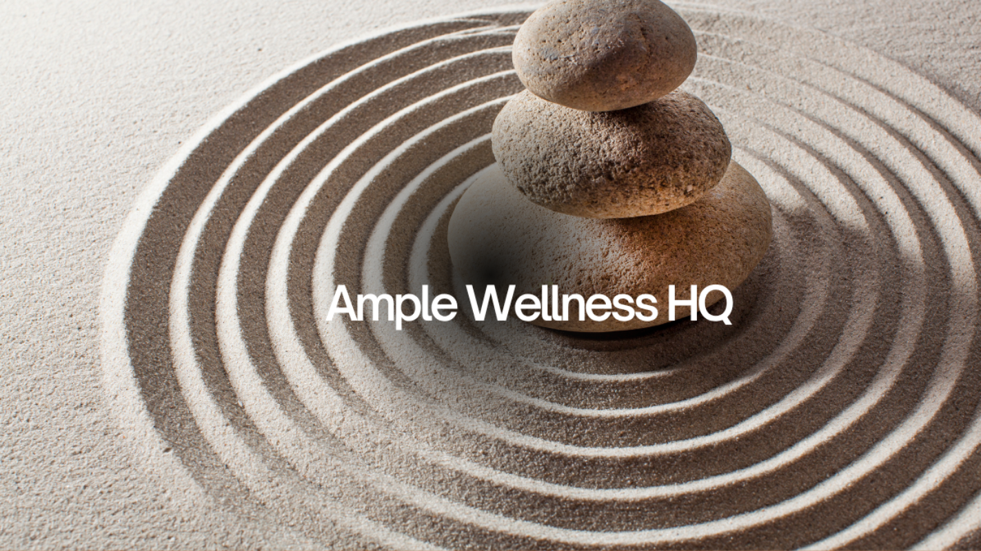 Three stacked stones in sand with 'Ample Wellness HQ' text